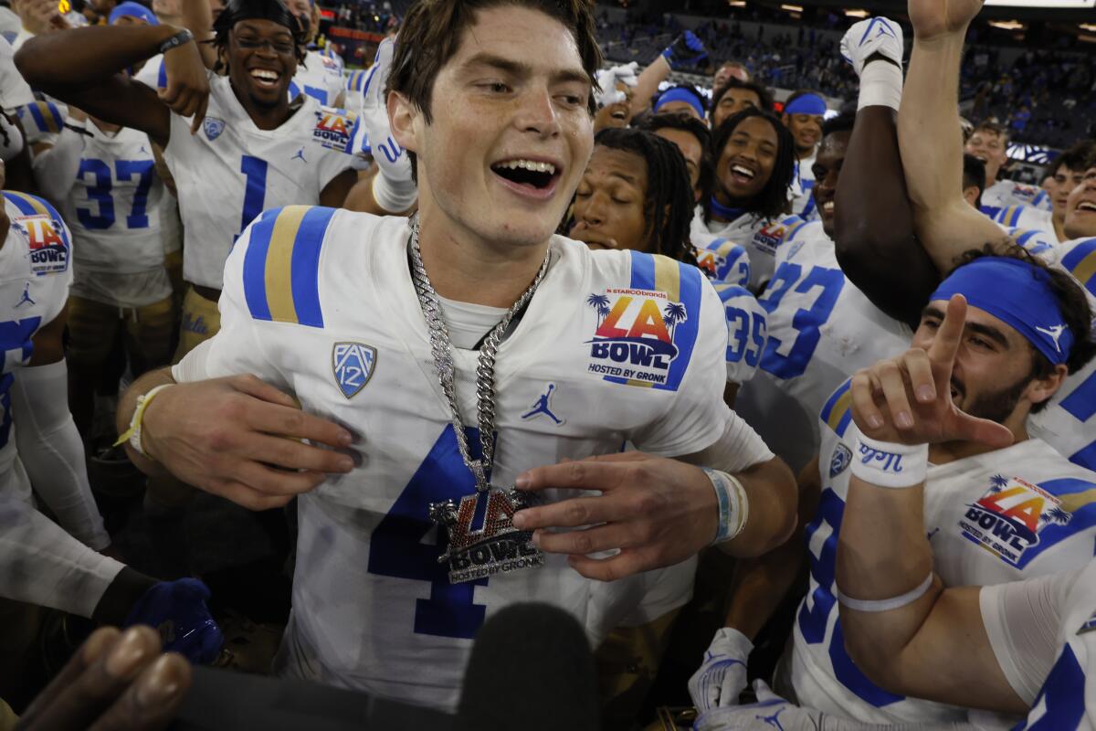 UCLA quarterback Ethan Garbers celebrates with his teammates after beating Boise State in the LA Bowl at SoFi Stadium.
