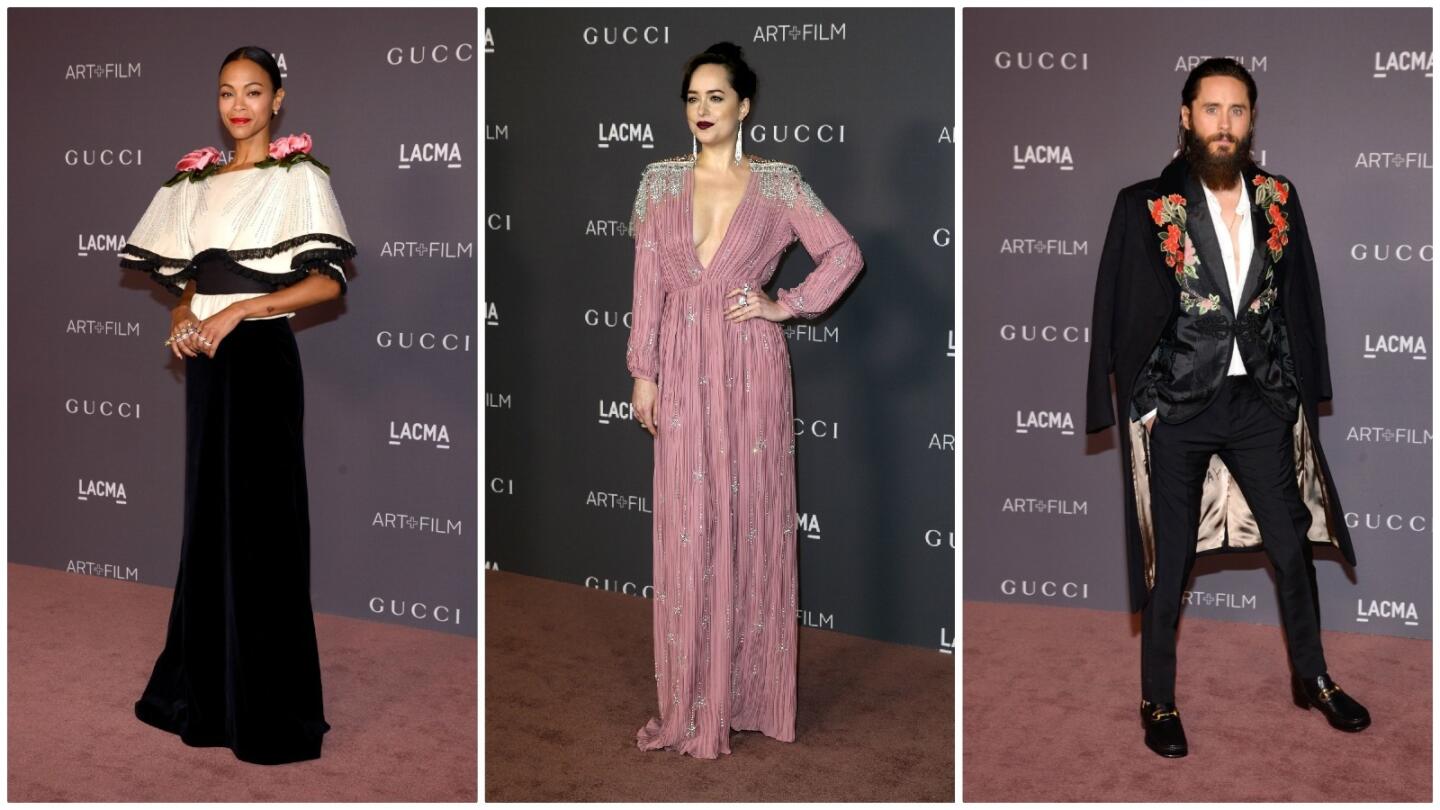 From left, attendees Zoe Saldana (in a black velvet gown with oversize plissé sculpted shoulders and hand-made silk decorative 3-D flowers on the collar from Gucci’s fall/winter 2017 collection); Dakota Johnson (in a pink silk satin gown with a deep V-neck and crystal embroidered appliqués on the shoulders from Gucci’s spring/summer 2018 collection); and Jared Leto (in a black jacquard evening jacket with floral embroidery detail from the Gucci 2018 Cruise collection worn under a black velvet floral embroidered coat).