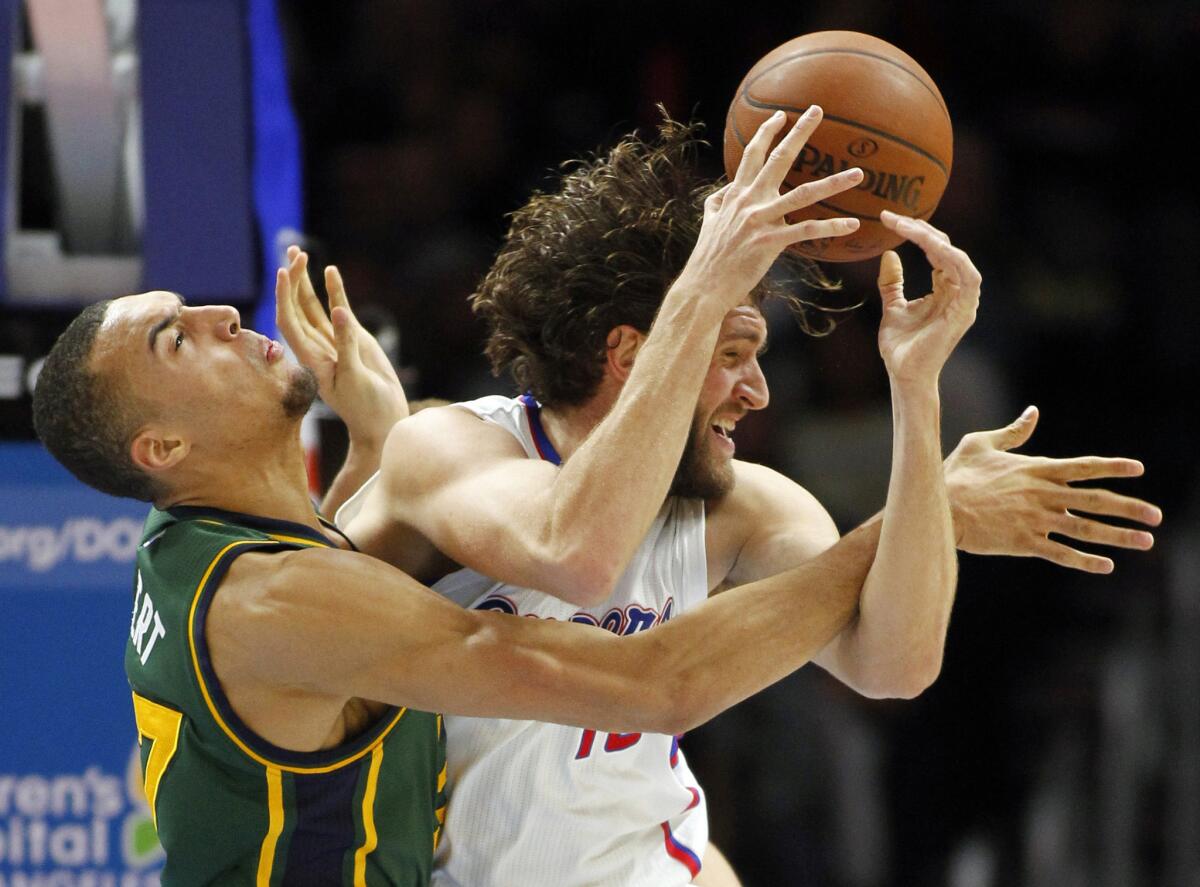 Clippers forward Spencer Hawes battles Jazz center Rudy Gobert in the second half Monday as Hawes returned to action after a nine-game absence.