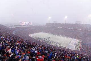 ORCHARD PARK, NEW YORK - JANUARY 22: Fans cheer as snow falls during the first half in the AFC Divisional Playoff game between the Cincinnati Bengals and the Buffalo Bills at Highmark Stadium on January 22, 2023 in Orchard Park, New York. (Photo by Timothy T Ludwig/Getty Images)