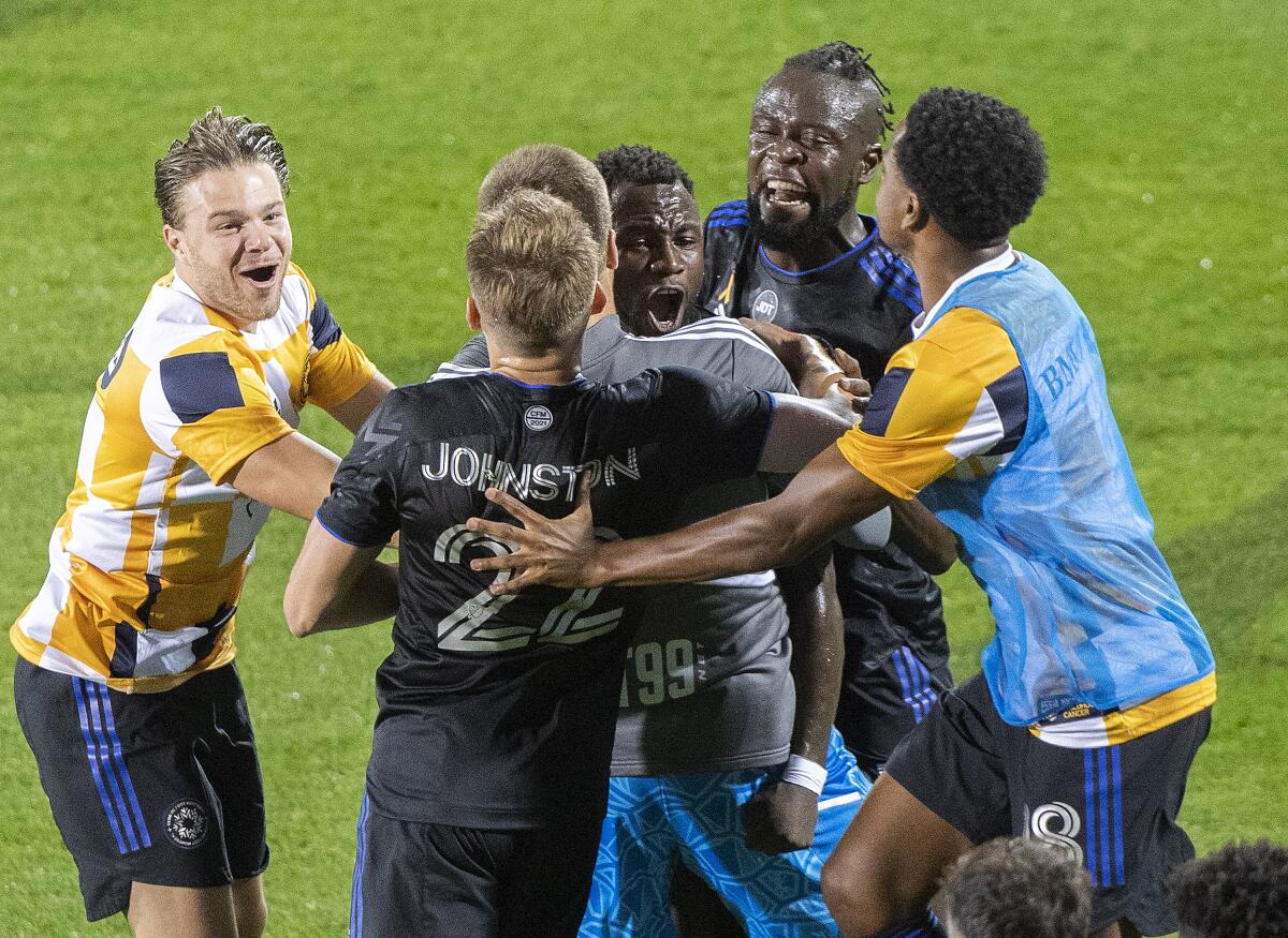 CF Montreal players celebrate a goal by Zachary Brault-Guillard (15) against the Columbus Crew during the second half of an MLS soccer match Friday, Sept. 9, 2022, in Montreal. (Graham Hughes/The Canadian Press via AP)