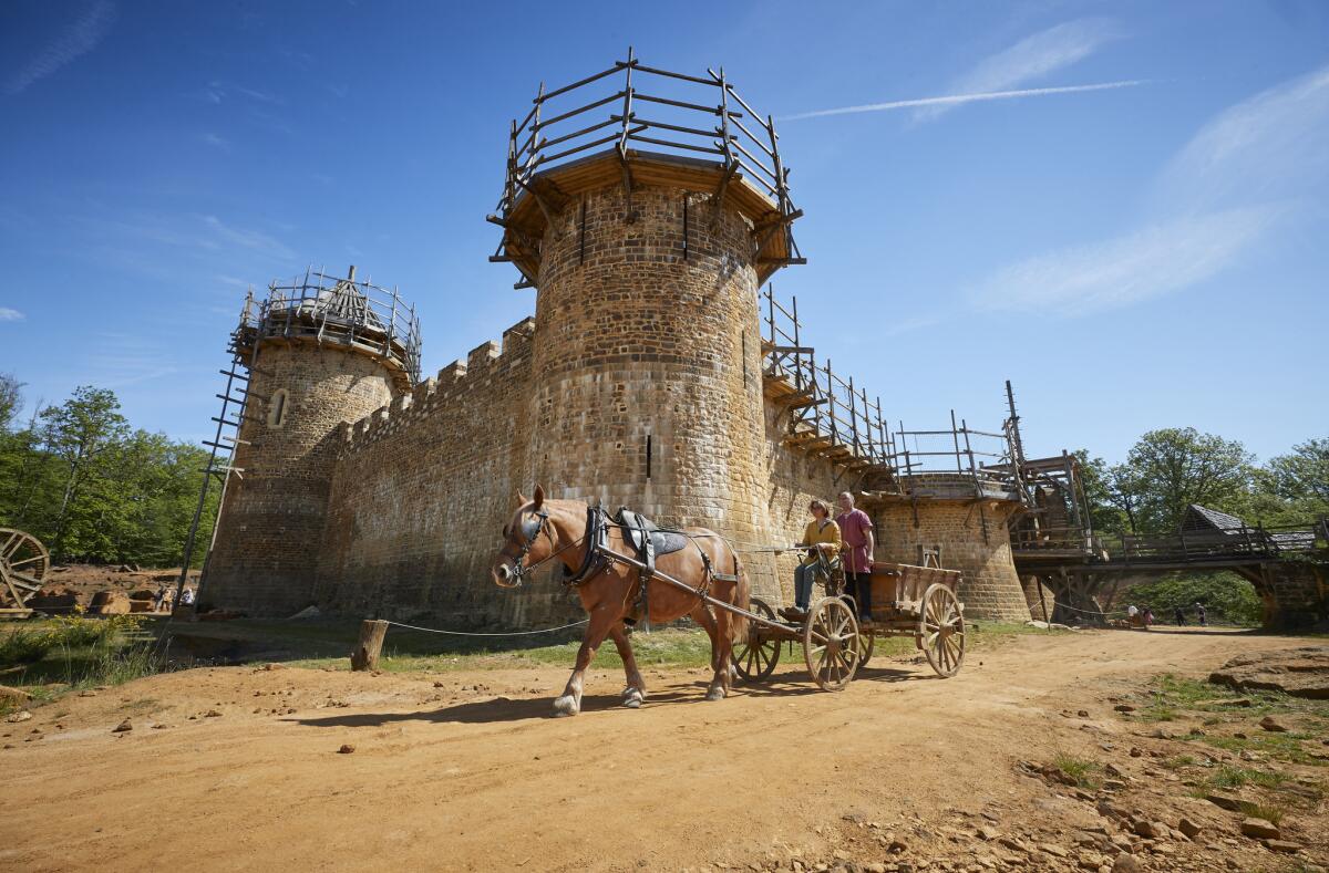 Laetitia Roux drives her horse and cart, which is used to transport materials around the Guedelon medieval castle project.