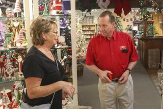 Store owner Dave Hansen (right) works with customer Ginny Williamson (left) at Canterbury Gardens on January 22, 2020 in Escondido, California. After 30 years in business the year round Christmas store is closing.