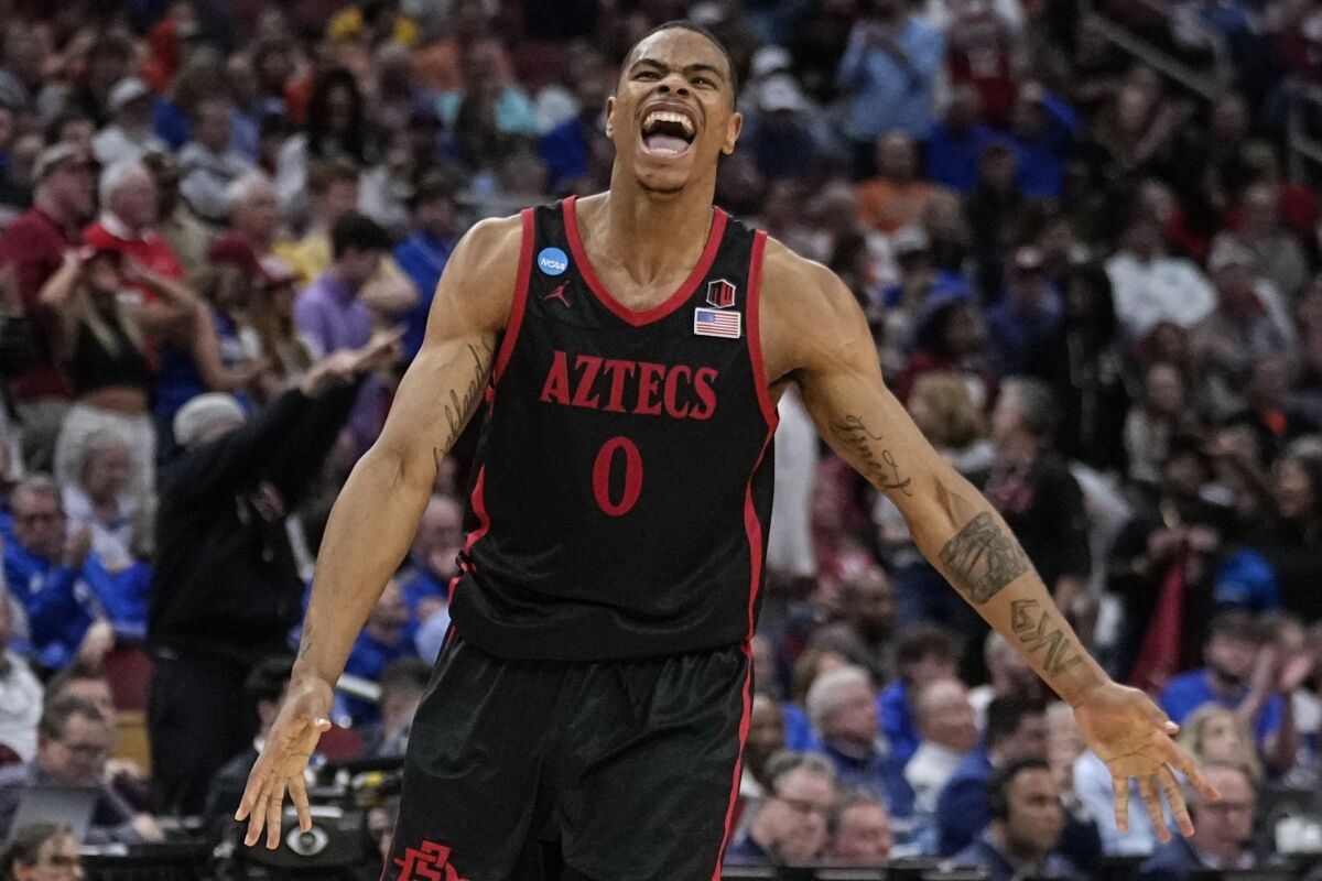 San Diego State forward Keshad Johnson (0) celebrates a win over Alabama in the second half of a Sweet 16 round college basketball game in the South Regional of the NCAA Tournament, Friday, March 24, 2023, in Louisville, Ky. San Diego State won 71-64. (AP Photo/John Bazemore)