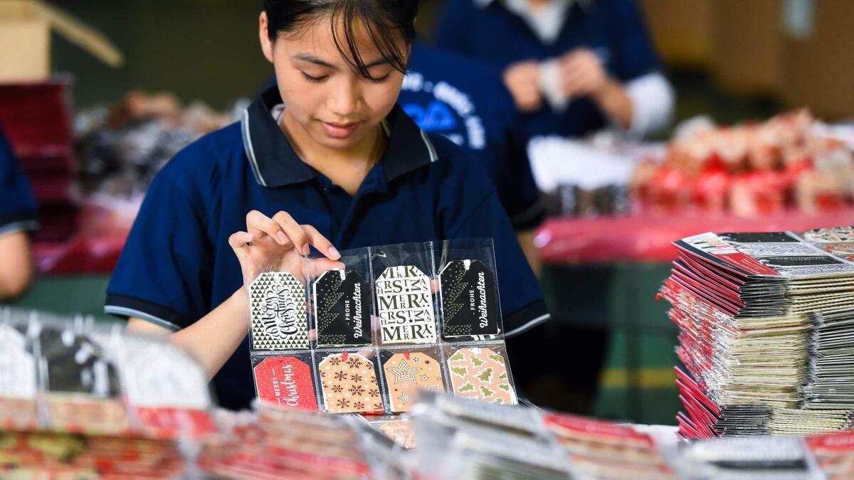 A worker makes Christmas cards in a factory in Hung Yen. Vietnam is now the eighth-biggest source of American imports, up from 12th place last year.