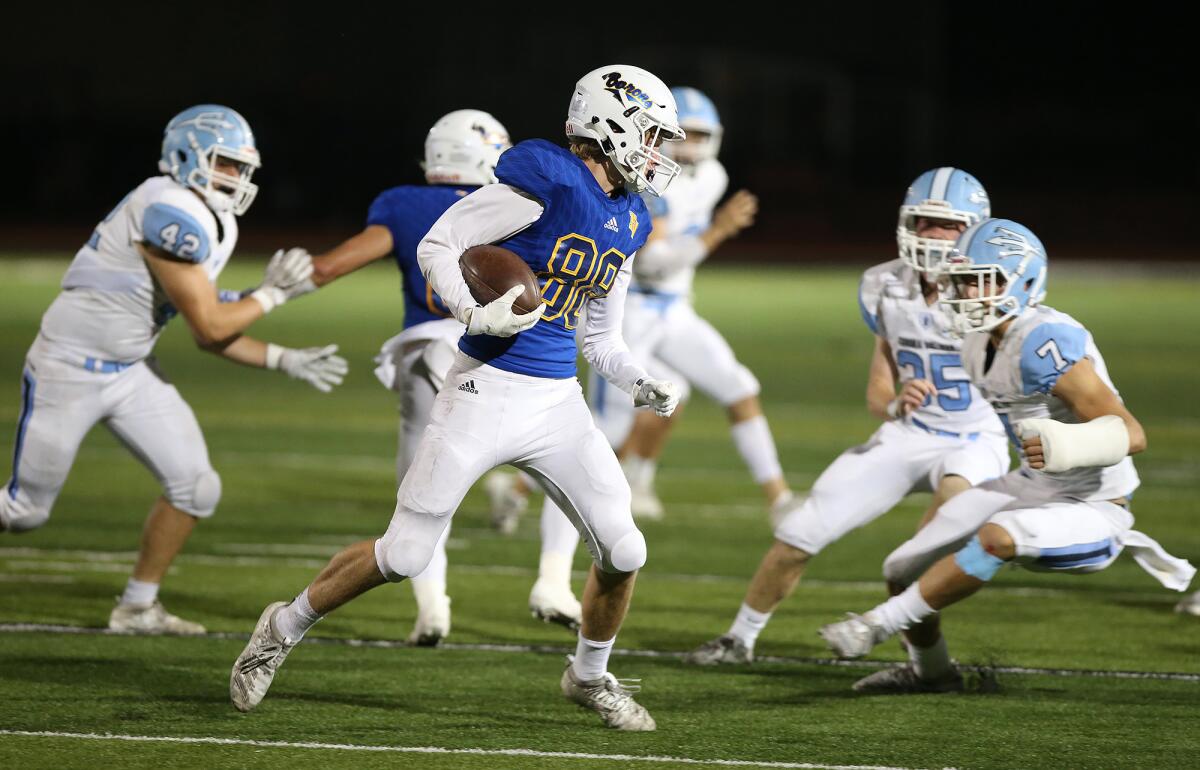 Fountain Valley wide receiver Blake Anderson is surrounded by Corona del Mar defenders after catching a pass in a Sunset League game at Cap Sheue Field on Oct. 17, 2019.