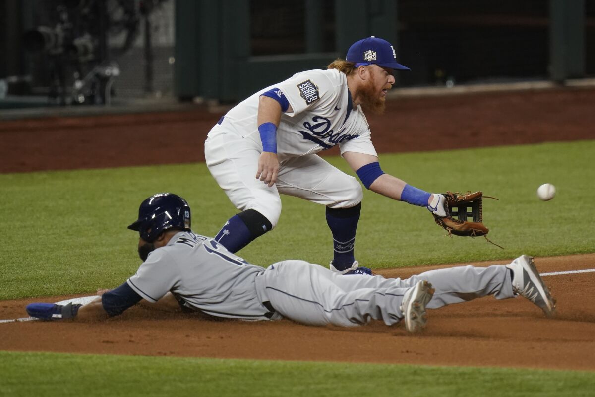 Tampa Bay's Manuel Margot slides in safe at third past Dodgers third baseman Justin Turner in the second inning of Game 2.