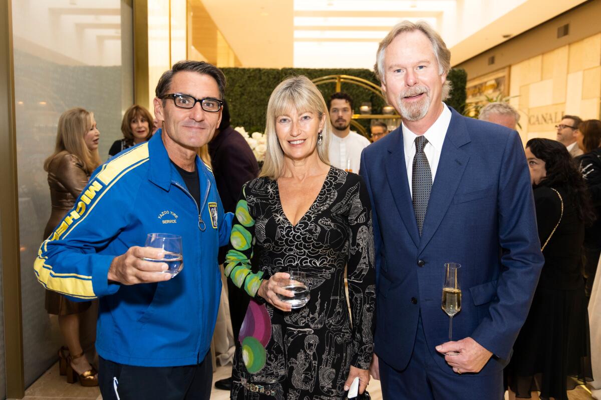 Laurent and Sophie Vrignaud, Anton Segerstrom attend Knife Pleat reception at South Coast Plaza. 