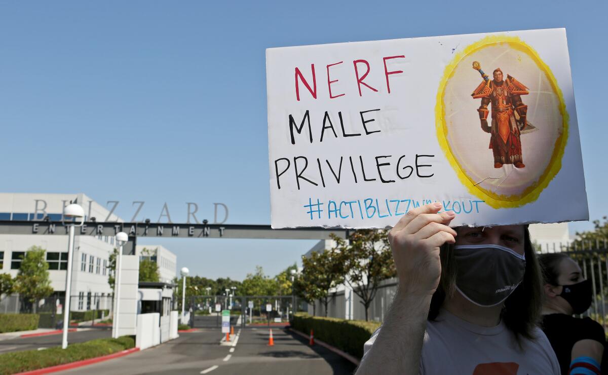 A person holds up a sign during a July 2021 walkout to protest sexual harassment and discrimination at Activision Blizzard.