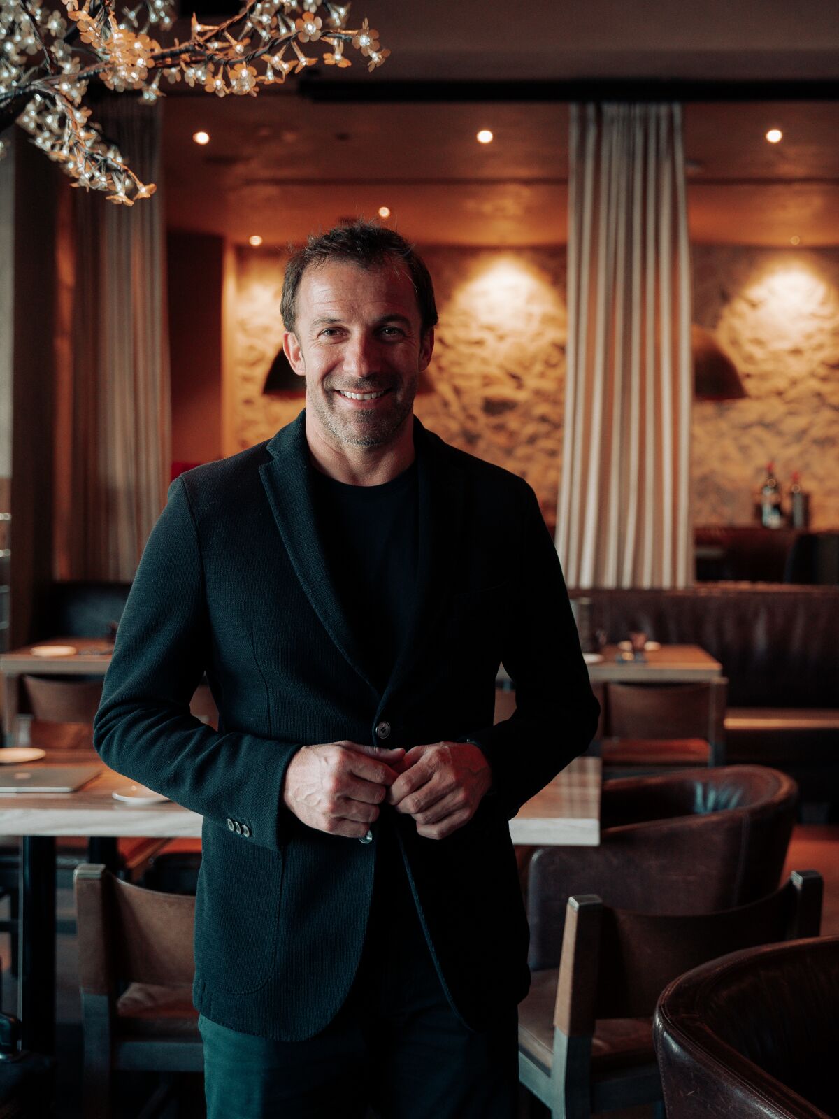 Former Italian soccer star Alessandro Del Piero stands in his restaurant n10.
