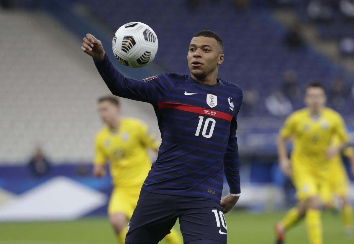 France's Kylian Mbappe controls the ball during the World Cup 2022 group D qualifying soccer match between France and Ukraine at the Start de de France stadium, in Saint Denis, north of Paris, Wednesday, March 24, 2021. (AP Photo/Thibault Camus)