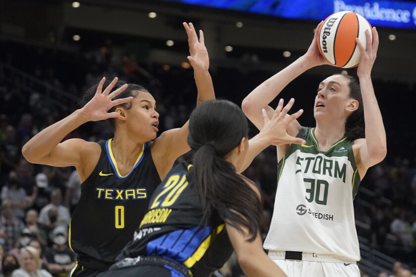 Seattle Storm forward Breanna Stewart (30) puts up a shot against Dallas Wings forward Satou Sabally (0) and guard Briann January (20) during the first half of a WNBA basketball game, Tuesday, July 12, 2022 in Seattle. (AP Photo/Ted S. Warren)