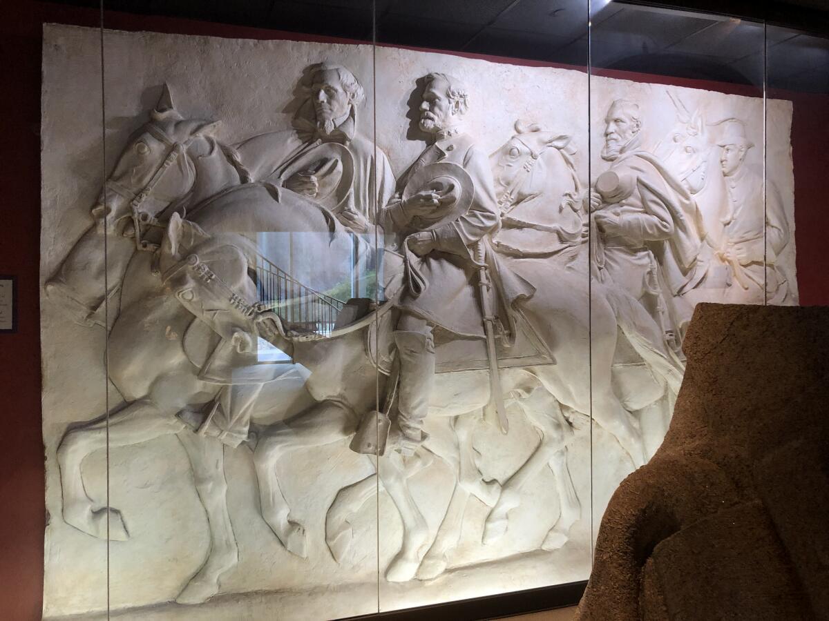 A vitrine shows a plaster model of a bas relief depicting Confederate leaders on horseback.