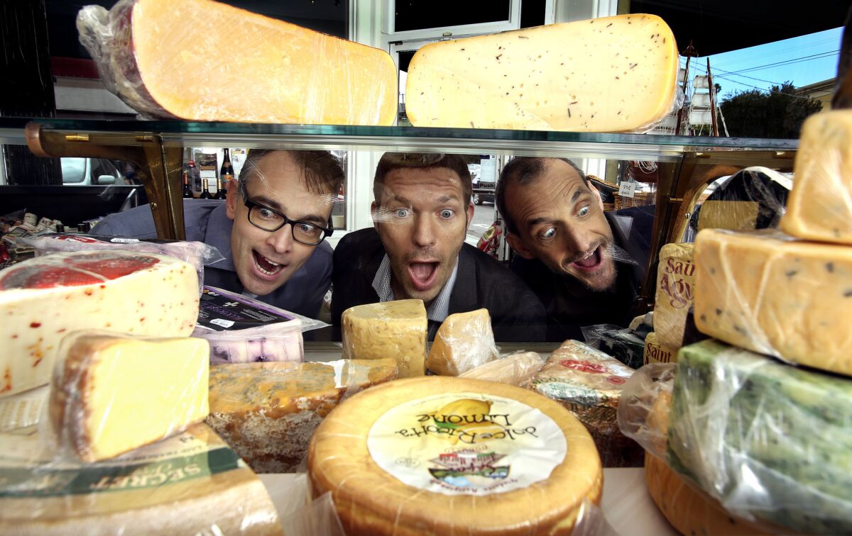 “Boxtrolls” directors Graham Annable, left, and Anthony Stacchi, right, ogle a display case of cheese with Laika boss Travis Knight.
