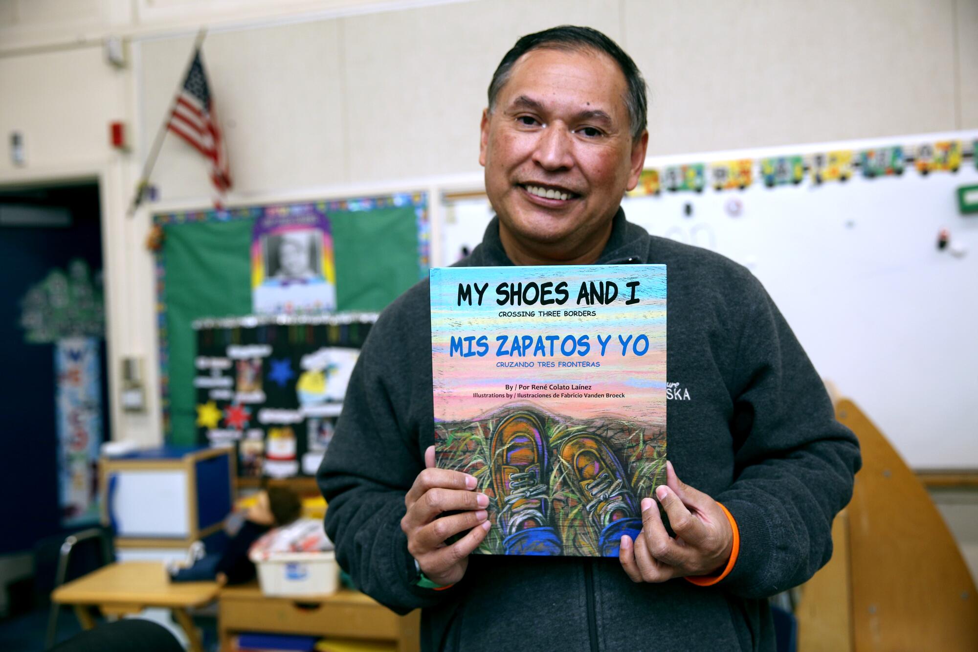 T-K teacher Rene Colato Lainez, 52, shows the first bilingual, English & Spanish, book he wrote, in his c