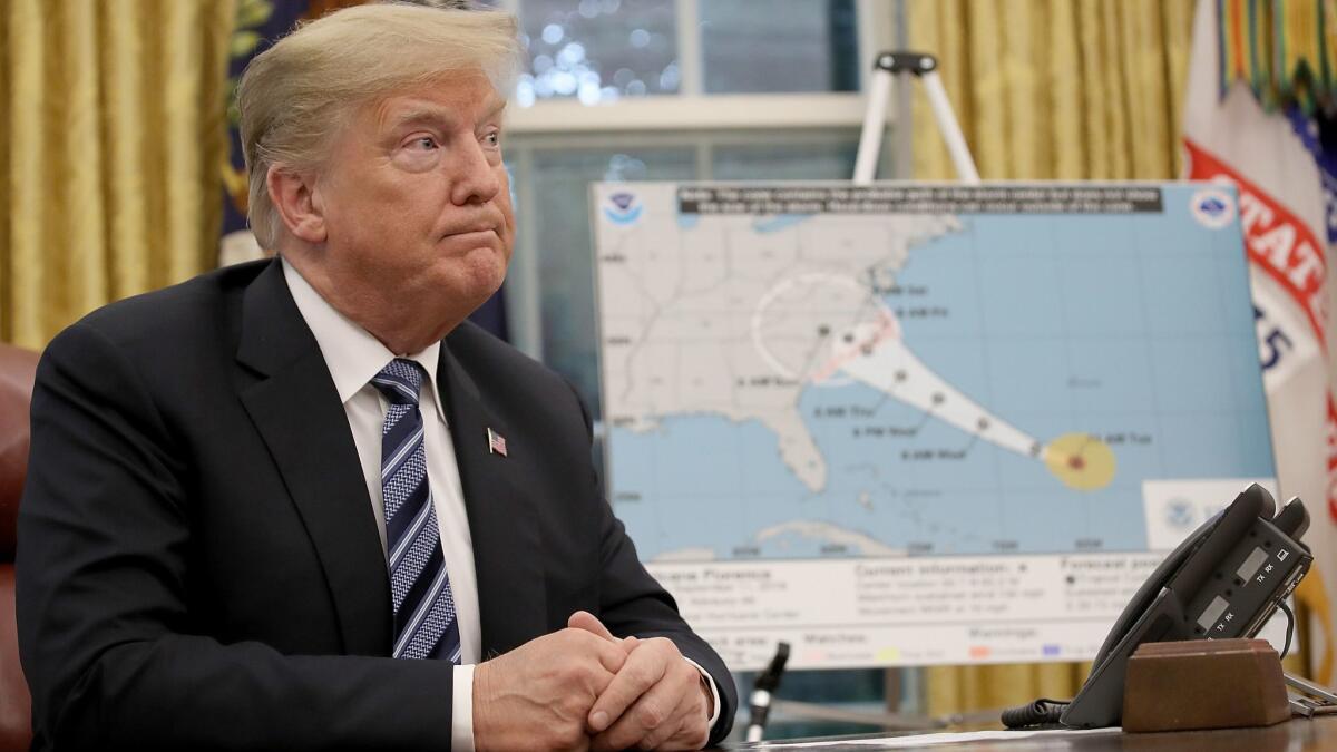President Trump listens during a briefing on Hurricane Florence in the Oval Office on Sept. 11.