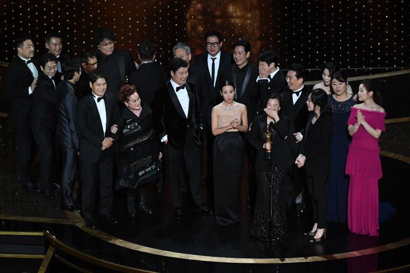 Parasite director Bong Joon Ho and cast members walking on the red carpet  at the 92nd Annual Academy Awards held at the Dolby Theatre in Hollywood,  California on Feb. 9, 2020. (Photo