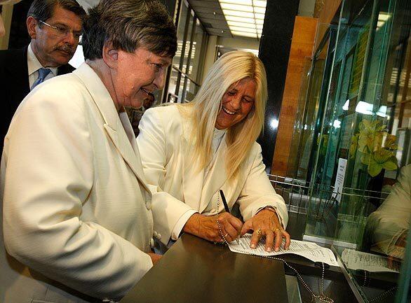Robin Tyler, left, and Diane Olson sign their marriage certificate. They were the first and only couple in Los Angeles County to obtain a marriage license Monday, after same-sex marriage became legal in California at 5:01 p.m. by order of the state Supreme Court. More coverage • With gay marriage now legal in California, it's the start of a couples' crush • Opponents of gay marriage stay mostly quiet -- for now