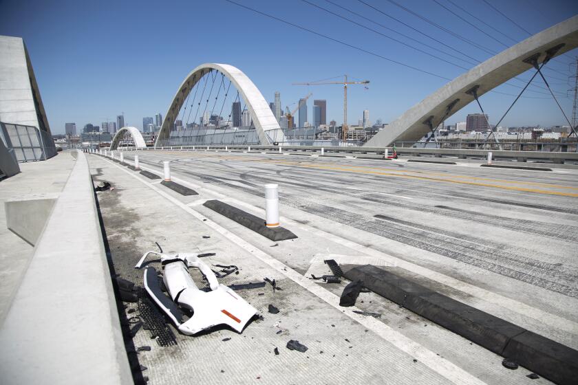 LOS ANGELES, CA - July 19: Car debris from a takeover crash remains on the 6th Street Viaduct on Tuesday, July 19, 2022 in Los Angeles, CA. (Myung J. Chun / Los Angeles Times)