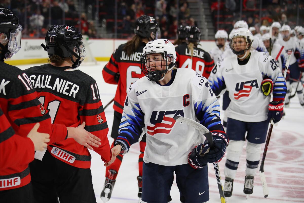 Kendall Coyne Schofield of the United States shakes hands with Canadian players after a 2-0 loss in Detroit on Feb. 17, 2019.