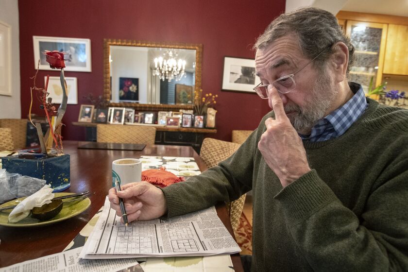LOS ANGELES, CA-MARCH 10, 2023: Jairo Angulo works on a Sudoku puzzle at his home in Los Angeles. He believes they're good for mental sharpness. Scientists say there is little evidence to support aid in memory loss. (Mel Melcon / Los Angeles Times)
