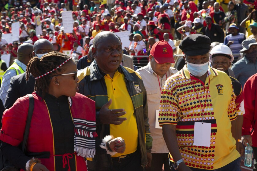 South African President, and African National Congress President Cyril Ramaphosa, venter, attends a May Day rally in Rustenburg, South Africa, Sunday, May 1, 2022. Ramaphosa who faces daunting political challenges including being defied within his party over his anti-corruption drive and derided as ineffective by the opposition, was forced by angry, striking mineworkers to abandon his Workers Day speech on May 1. (AP Photo/Denis Farrell)