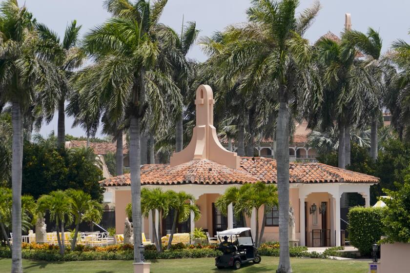Security moves in a golf cart at former President Donald Trump's Mar-a-Lago estate, Tuesday, Aug. 9, 2022, in Palm Beach, Fla. The FBI searched Trump's Mar-a-Lago estate as part of an investigation into whether he took classified records from the White House to his Florida residence, people familiar with the matter said Monday. (AP Photo/Lynne Sladky)