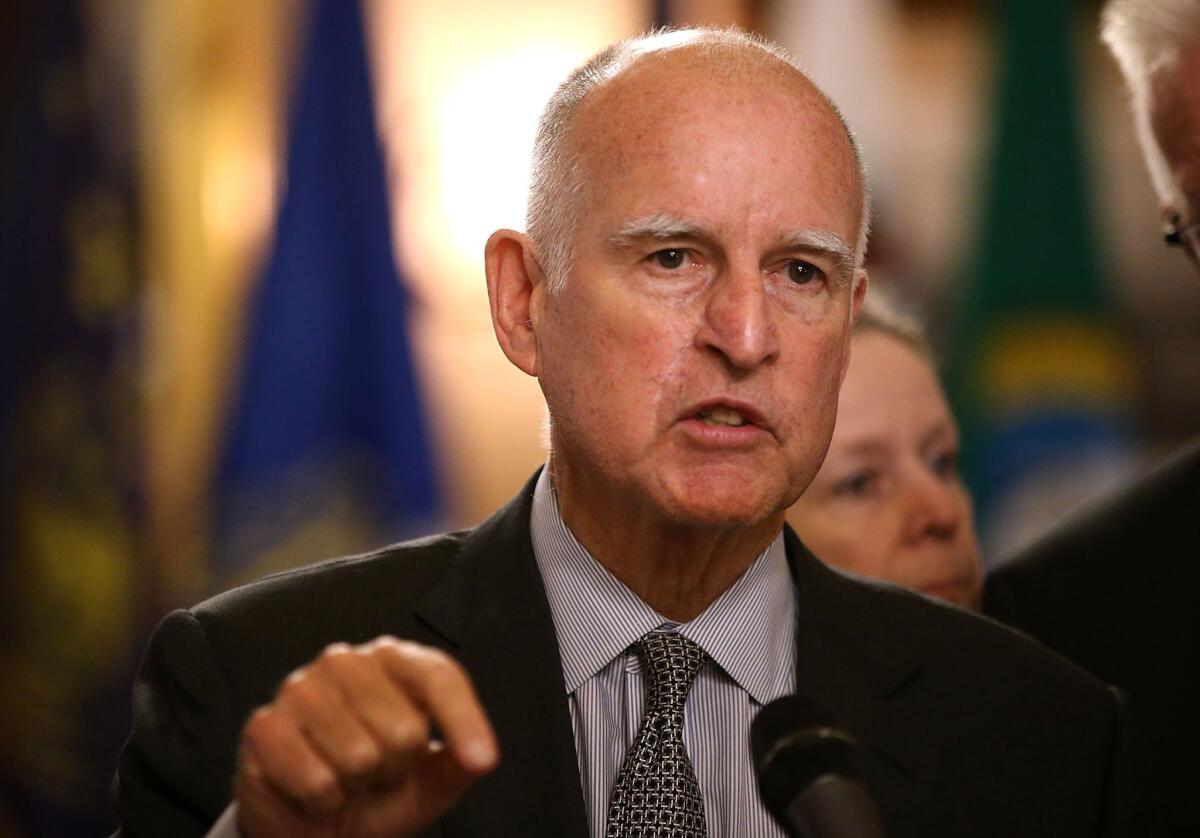 Gov. Jerry Brown, pictured here speaking at the signing of a climate change pact in Sacramento in May, will travel to the Vatican later this month.
