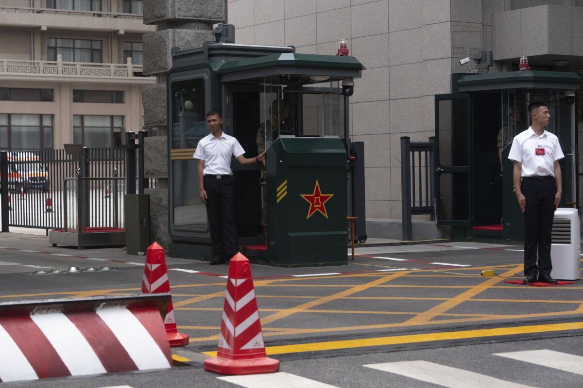 Chinese security personnel guard on duty at the entrance to Jingxi Hotel 