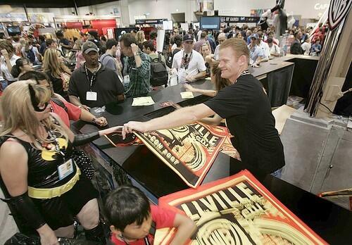 Super swag: fans of "Superman" and "Smallville" line up for a freebie from Warner Brother Studios.