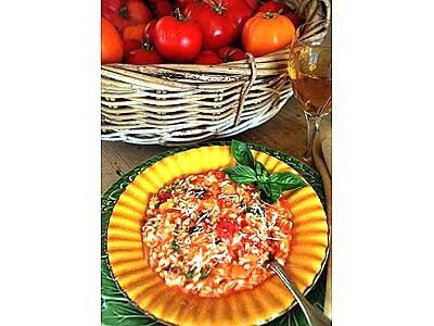 Tomato Risotto stands beside a basket of local heirloom tomatoes.