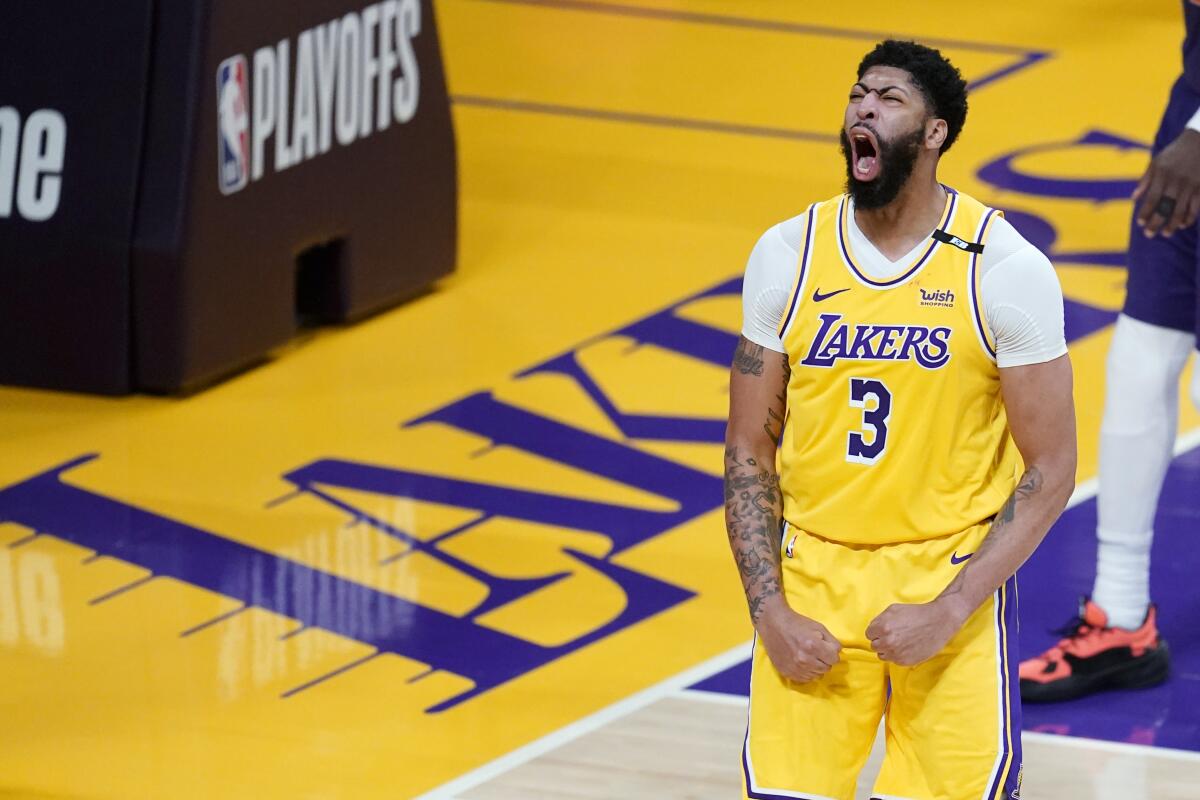 Lakers forward Anthony Davis celebrates after scoring during a game.