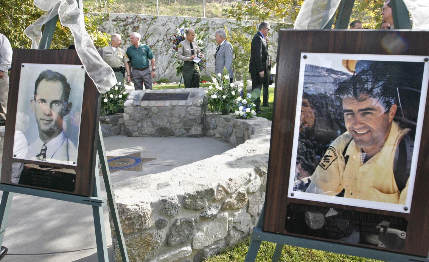 Los Angeles County Sheriff Lee Baca, center talks to attendees of a memorial dedication at the CV Sheriff's station for fallen deputies David A. Horr, left and Charles O. Rea, right, on Monday, October 24, 2011.