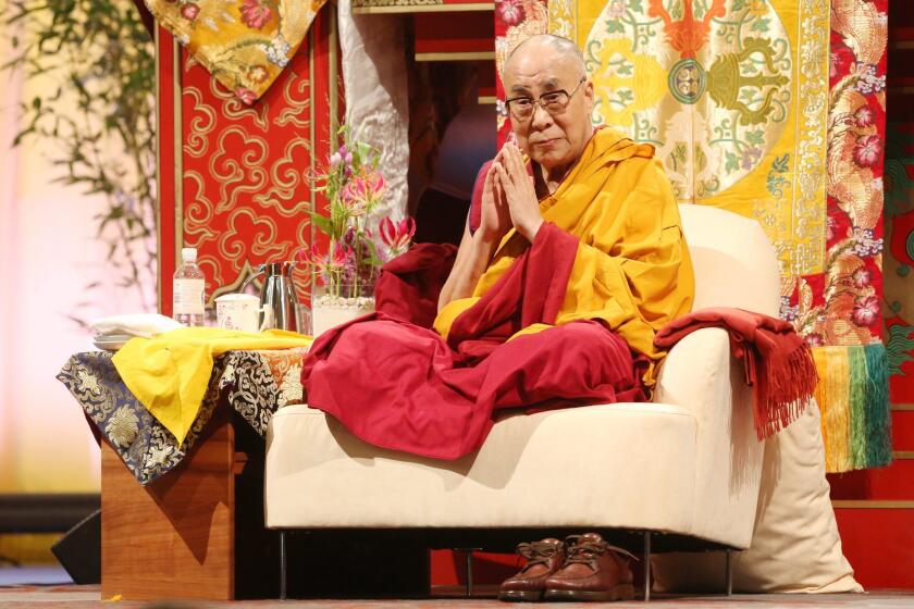 The Dalai Lama, spiritual leader of Tibetan Buddhists, sits onstage during an event in August in Hamburg, Germany.