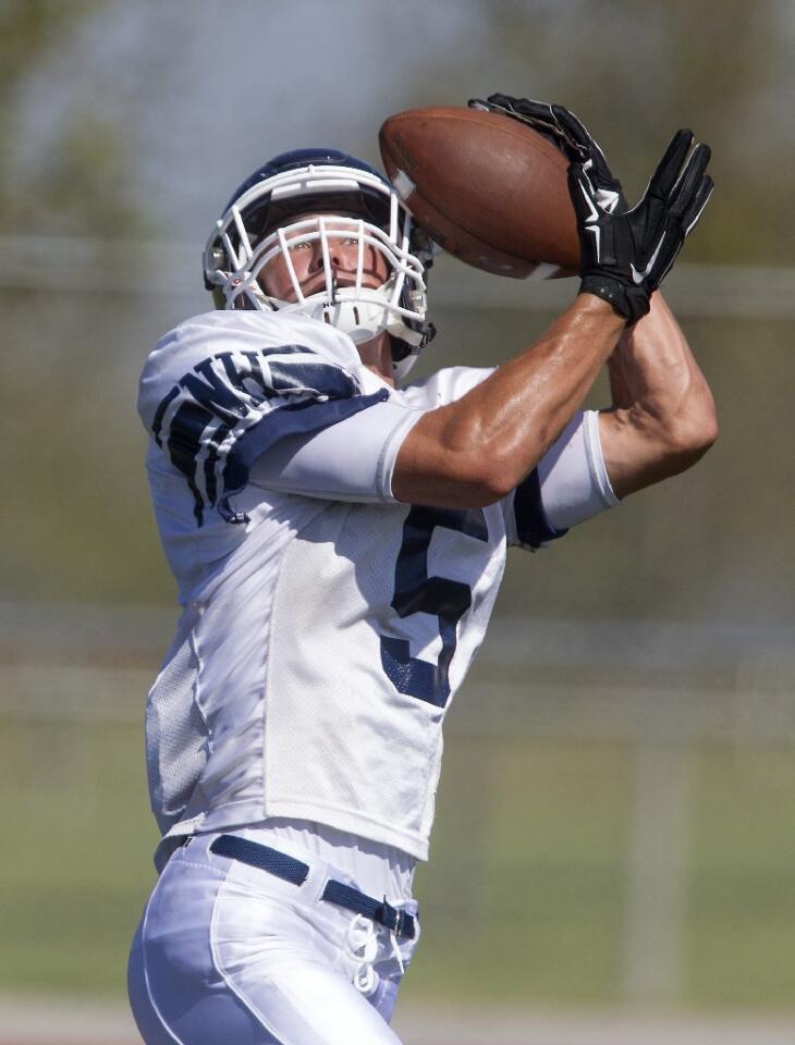 Newport Harbor High's Cole Kinder makes a catch during a scrimmage against Estancia at Jim Scott Stadium on Friday.