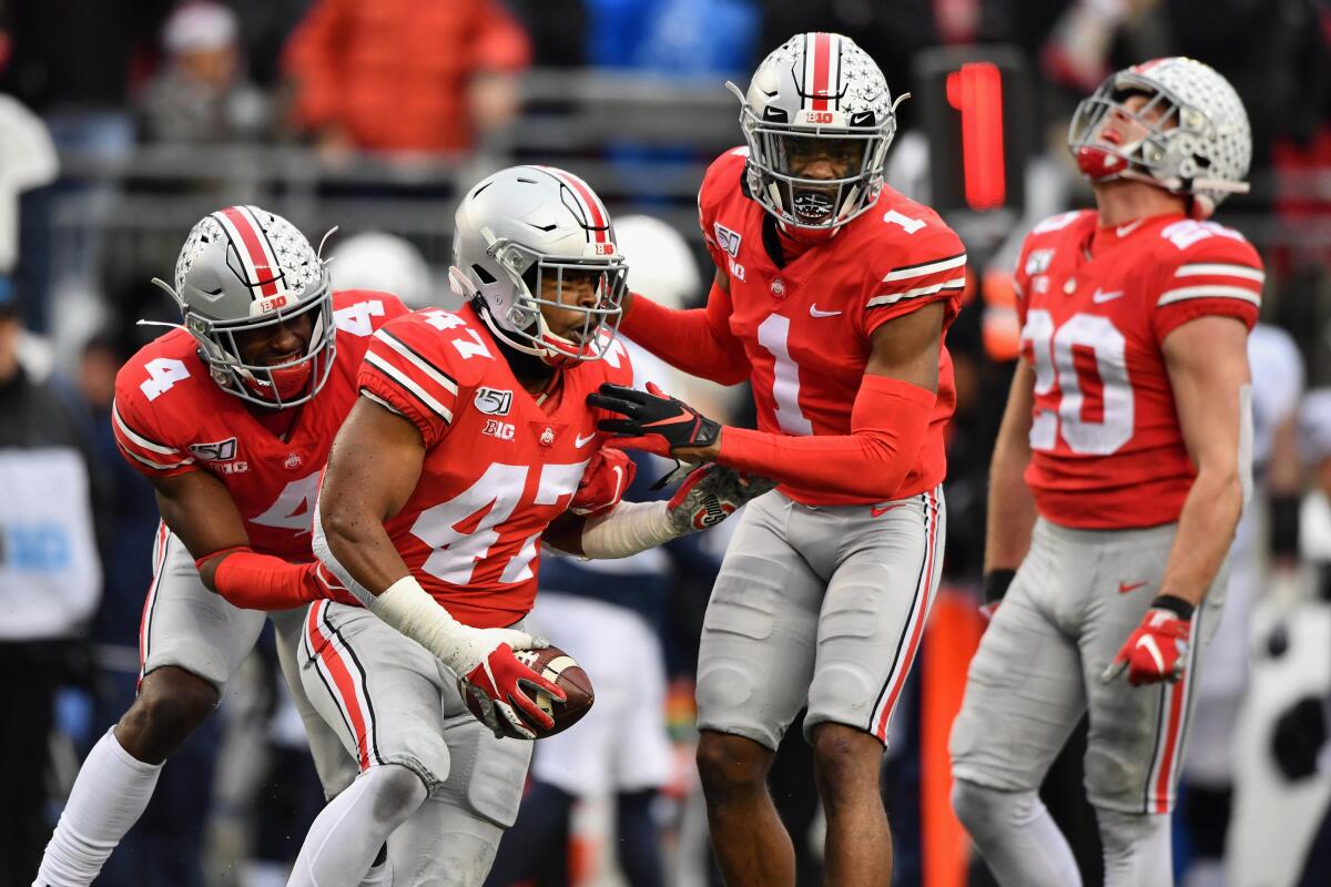 Justin Hilliard celebrates with his Ohio State teammates after intercepting a pass.