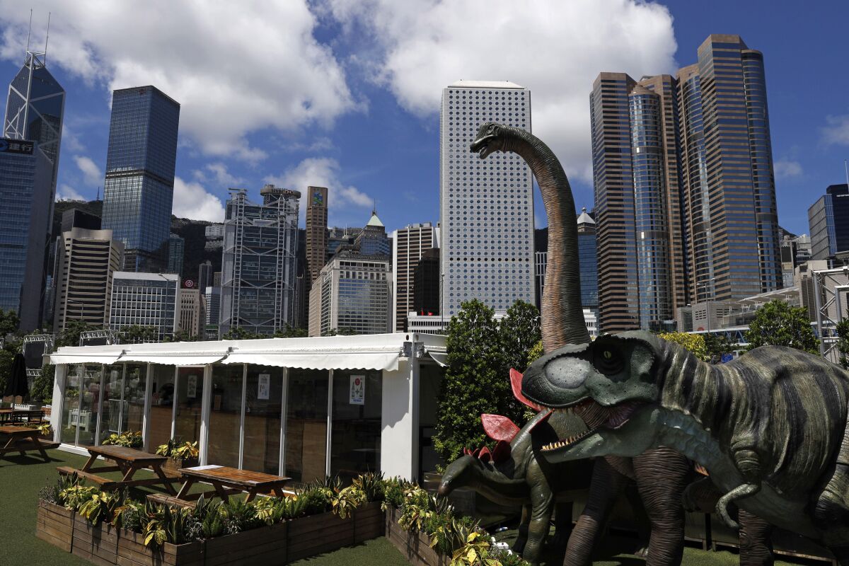Dinosaur statues are displayed at the Central, a business district in Hong Kong. 