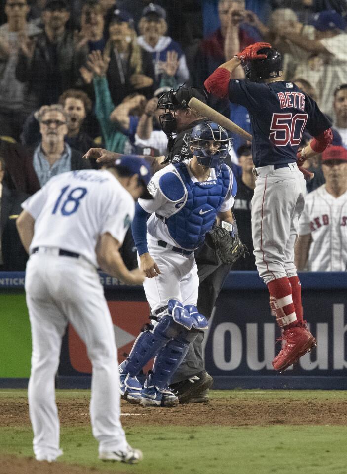 Dodgers relief pitcher Kenta Maeda strikes outRed Sox right fielder Mookie Betts in the 15th inning.