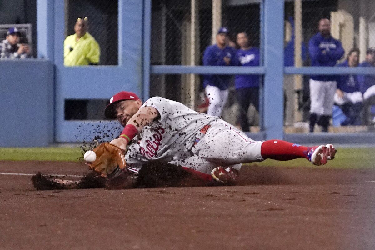 Philadelphia Phillies left fielder Kyle Schwarber can't get to a foul ball hit by the Dodgers' Freddie Freeman.