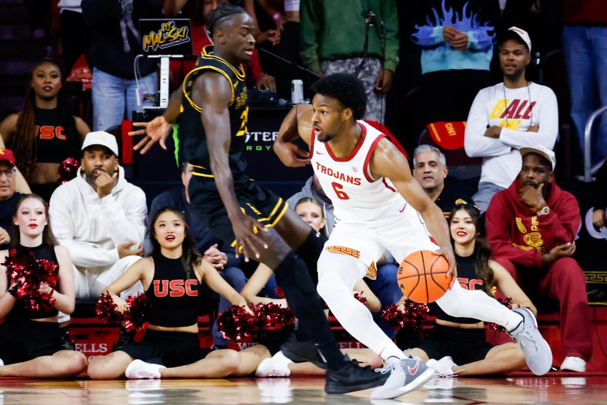 USC guard Bronny James controls the ball in front of Long Beach State forward Aboubacar Traore.