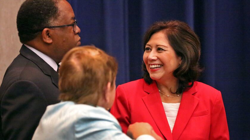 Los Angeles County Supervisor Hilda L. Solis, right, talks to Supervisors Mark Ridley Thomas and Sheila Kuehl, left to right, in 2015. A proposal in Sacramento would expand the board from five to seven members.