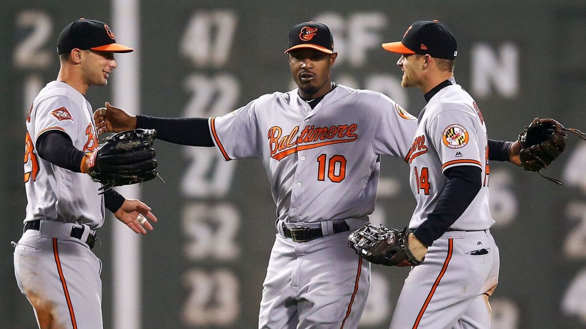 Baltimore outfielder Adam Jones, center, celebrates with teammates Joey Rickard, left, and Craig Gentry after the Orioles' victory over the Boston Red Sox at Fenway Park on May 1.