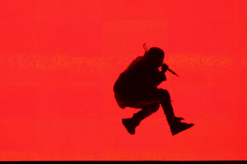 Kanye West is silhouetted onstage at the Made in America festival in downtown Los Angeles.