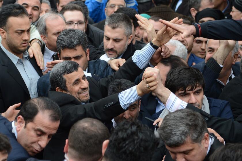 Former Iranian President Mahmoud Ahmadinejad leaves Bursa Grand Mosque after Friday prayer on February 27, 2015. Mahmoud Ahmadinejad came Bursa to attend a commemorating for Necmettin Erbakan organized by Erbakan Association.