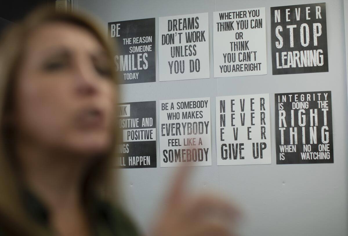  Signs with affirming words hang on the wall at the counseling and wellness center 