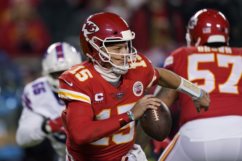 Kansas City Chiefs quarterback Patrick Mahomes (15) looks to pass during the first half of an NFL divisional round playoff football game against the Buffalo Bills, Sunday, Jan. 23, 2022, in Kansas City, Mo. (AP Photo/Charlie Riedel)