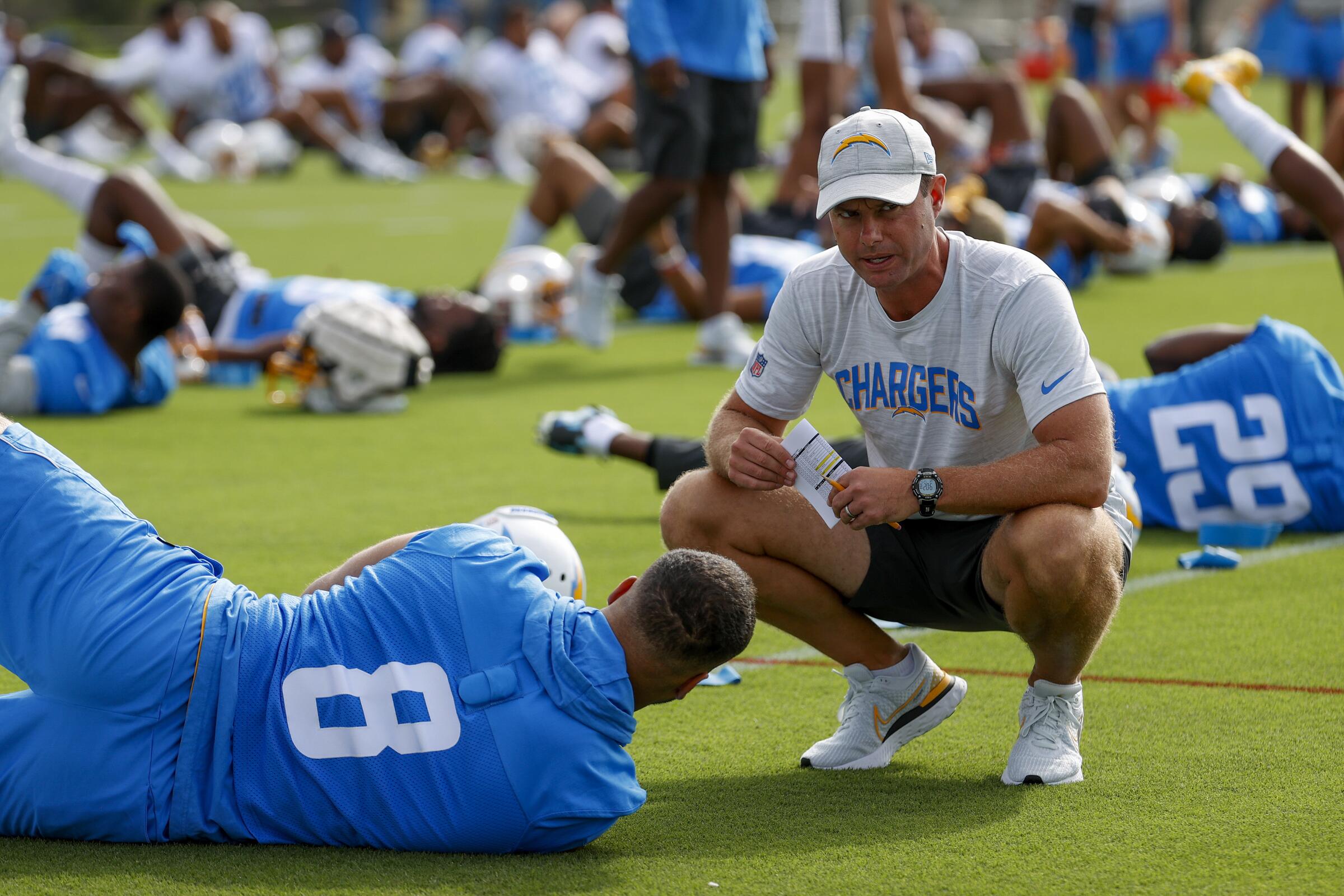  Chargers head coach Brandon Staley, right, talks to outside linebacker Kyle Van Noy (8) during camp.
