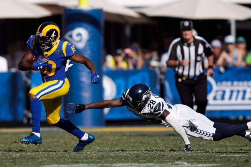 Los Angeles Rams' Pharoh Cooper carries the ball past Seattle Seahawks' Justin Coleman during an NFL football game Sunday, Oct. 8, 2017, in Los Angeles. (AP Photo/Jae C. Hong)