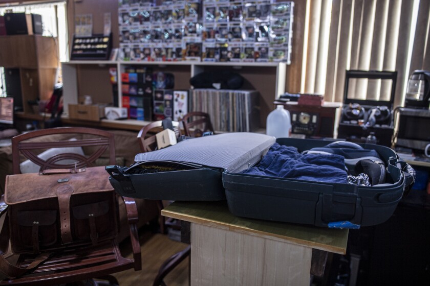 A mostly packed suitcases sit on a bar at Laurens van Beek's home in Iowa City, Iowa.