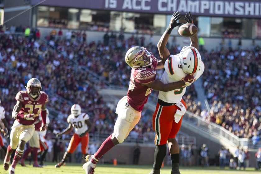 Florida State defensive back Asante Samuel Jr. (26) breaks up a pass intended for Miami tight end Brevin Jordan (9) in the first half of an NCAA college football game in Tallahassee, Fla., Saturday, Nov. 2, 2019. (AP Photo/Mark Wallheiser)